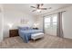 Comfortable bedroom with a ceiling fan, carpeted floor, and natural light at 5875 N 195Th Dr, Litchfield Park, AZ 85340
