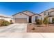 Charming single-story home featuring a two-car garage and a well-maintained desert landscape at 5875 N 195Th Dr, Litchfield Park, AZ 85340