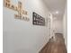 Inviting hallway with modern wood flooring, decorative wall art, and recessed lighting at 5875 N 195Th Dr, Litchfield Park, AZ 85340