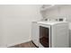 This laundry room features modern appliances, a white shelf, and wood-look flooring at 5875 N 195Th Dr, Litchfield Park, AZ 85340