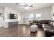 Bright living room with wood floors, comfortable seating, and a view of the backyard at 5875 N 195Th Dr, Litchfield Park, AZ 85340