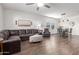 Spacious living room featuring hardwood floors, comfortable seating, and a dining area at 5875 N 195Th Dr, Litchfield Park, AZ 85340