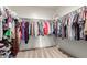 Organized walk-in closet with ample storage space for clothing and accessories at 5875 N 195Th Dr, Litchfield Park, AZ 85340