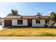 Charming single story home with a well-kept yard, attached garage, and inviting front entrance at 6731 W Hazelwood St, Phoenix, AZ 85033