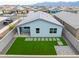 Aerial view of backyard with artificial turf, patio, and block wall fencing at 6810 W Pedro Ln, Laveen, AZ 85339