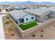 Aerial view of backyard featuring artificial turf, patio, and privacy wall at 6810 W Pedro Ln, Laveen, AZ 85339