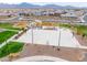 Aerial view of a community park with a playground, a basketball court, picnic areas and walking paths at 6810 W Pedro Ln, Laveen, AZ 85339