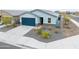 View of home with blue garage door, rock landscaping, and paved driveway at 6810 W Pedro Ln, Laveen, AZ 85339