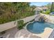 Aerial view of a lush backyard featuring a custom pool with rock waterfall and mature trees at 7745 E Calle De Las Brisas --, Scottsdale, AZ 85255