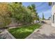 Beautiful backyard featuring a well-manicured lawn and a stunning rock waterfall that feeds into the pool area at 7745 E Calle De Las Brisas --, Scottsdale, AZ 85255