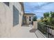 Outdoor balcony featuring stucco railing, a door to interior, and views of lush trees at 7745 E Calle De Las Brisas --, Scottsdale, AZ 85255