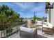 Outdoor balcony featuring stylish furniture and views of lush trees and neighboring properties at 7745 E Calle De Las Brisas --, Scottsdale, AZ 85255