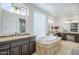 Luxurious bathroom with dual vanities, a soaking tub with tile surround, and a glass block window at 7745 E Calle De Las Brisas --, Scottsdale, AZ 85255