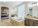 Bathroom featuring a soaking tub with tile surround, dual vanities, and tiled floors at 7745 E Calle De Las Brisas --, Scottsdale, AZ 85255