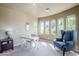 Bright bedroom with large windows, neutral carpet, and a charming seating area with comfortable chair at 7745 E Calle De Las Brisas --, Scottsdale, AZ 85255