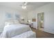 Bright bedroom features white bedding, desk, and ensuite bathroom access at 7745 E Calle De Las Brisas --, Scottsdale, AZ 85255
