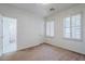 Empty bedroom with shuttered windows and adjoining bath at 7745 E Calle De Las Brisas --, Scottsdale, AZ 85255