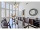 Elegant dining room with contemporary chandelier, wainscoting, and views of the backyard at 7745 E Calle De Las Brisas --, Scottsdale, AZ 85255