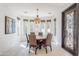 Bright dining room featuring a modern light fixture, large windows, and stylish seating at 7745 E Calle De Las Brisas --, Scottsdale, AZ 85255