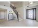 Bright foyer featuring a curved staircase, tile flooring, and a decorative front door at 7745 E Calle De Las Brisas --, Scottsdale, AZ 85255