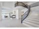 Bright foyer featuring a curved staircase, fireplace, and open floor plan at 7745 E Calle De Las Brisas --, Scottsdale, AZ 85255