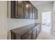 Hallway features dark wood cabinets and drawers, white walls and carpet flooring at 7745 E Calle De Las Brisas --, Scottsdale, AZ 85255