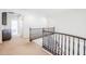 Hallway with carpet, dark wood banister, white walls, and arched entry to another room at 7745 E Calle De Las Brisas --, Scottsdale, AZ 85255