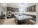 Spacious kitchen features an island, custom cabinets, stainless steel appliances, and neutral countertops at 7745 E Calle De Las Brisas --, Scottsdale, AZ 85255