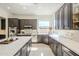 Bright kitchen featuring stainless steel appliances, dark wood cabinets, and neutral countertops at 7745 E Calle De Las Brisas --, Scottsdale, AZ 85255