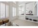 Bright living room featuring high ceilings, clerestory windows with plantation shutters, and neutral decor at 7745 E Calle De Las Brisas --, Scottsdale, AZ 85255