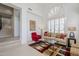 Bright living room with high ceilings, arched windows with white shutters, and staircase at 7745 E Calle De Las Brisas --, Scottsdale, AZ 85255