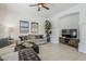 Living room with a ceiling fan, cozy seating, decorative art, and a green plant at 7745 E Calle De Las Brisas --, Scottsdale, AZ 85255
