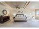 Inviting primary bedroom with a decorative tray ceiling, neutral tones, carpet, and comfortable bedding at 7745 E Calle De Las Brisas --, Scottsdale, AZ 85255