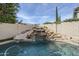 Lush backyard featuring a custom pool with rock waterfall feature and meticulous landscaping at 7745 E Calle De Las Brisas --, Scottsdale, AZ 85255