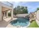 Resort-style pool with rock waterfall feature and lush landscaping creating a private oasis at 7745 E Calle De Las Brisas --, Scottsdale, AZ 85255