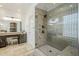 Bathroom featuring a glass enclosed shower with custom tilework, multiple shower heads, and seating at 7745 E Calle De Las Brisas --, Scottsdale, AZ 85255