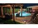 Inviting backyard pool with covered patio and pergola seating, perfect for outdoor relaxation and entertaining at 7800 E Via Del Futuro E --, Scottsdale, AZ 85258