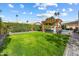 Lush backyard featuring green grass, a pergola, and well-maintained hedges at 7800 E Via Del Futuro E --, Scottsdale, AZ 85258