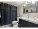 Well-lit bathroom with a dark vanity, a large mirror, and a sleek shower curtain at 7800 E Via Del Futuro E --, Scottsdale, AZ 85258