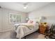 Bright bedroom with plantation shutters, ceiling fan, and a charming nightstand featuring floral accents at 7800 E Via Del Futuro E --, Scottsdale, AZ 85258