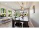 Bright dining room with a large wooden table, bench seating, and views of the landscaped backyard at 7800 E Via Del Futuro E --, Scottsdale, AZ 85258