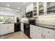 Well-lit kitchen with white cabinetry, black appliances, and tile backsplash at 7800 E Via Del Futuro E --, Scottsdale, AZ 85258