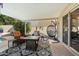 Covered patio with comfortable seating, a fire pit, and stylish decor at 7800 E Via Del Futuro E --, Scottsdale, AZ 85258