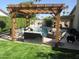 Inviting pool area featuring a pergola, comfortable seating, and a tranquil water feature for outdoor relaxation at 7800 E Via Del Futuro E --, Scottsdale, AZ 85258