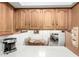 Kitchen features wooden cabinets and a view into the dining room and bedroom at 849 E Lancaster Cir, Florence, AZ 85132