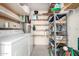 Utility room with a washing machine, a water heater and multiple shelves for storage at 849 E Lancaster Cir, Florence, AZ 85132