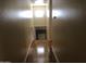 Hallway with wood-style floors leading to an interior door at 8870 N 48Th Ln, Glendale, AZ 85302
