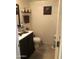 Cozy powder room featuring decorative shelves and contemporary sink at 8870 N 48Th Ln, Glendale, AZ 85302
