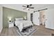 Stylish bedroom showcasing a sliding barn door to the ensuite bathroom and decorative green accent wall at 9036 N 51St Ln, Glendale, AZ 85302