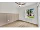 Inviting bedroom with a board and batten accent wall and bright window offering a pleasant view at 9036 N 51St Ln, Glendale, AZ 85302